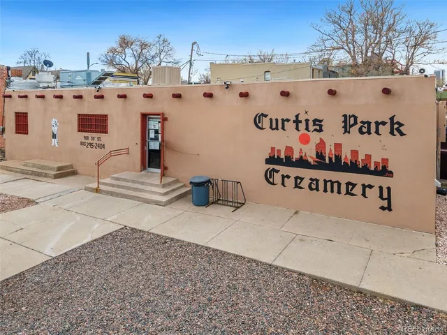 a view of patio with chairs and umbrellas