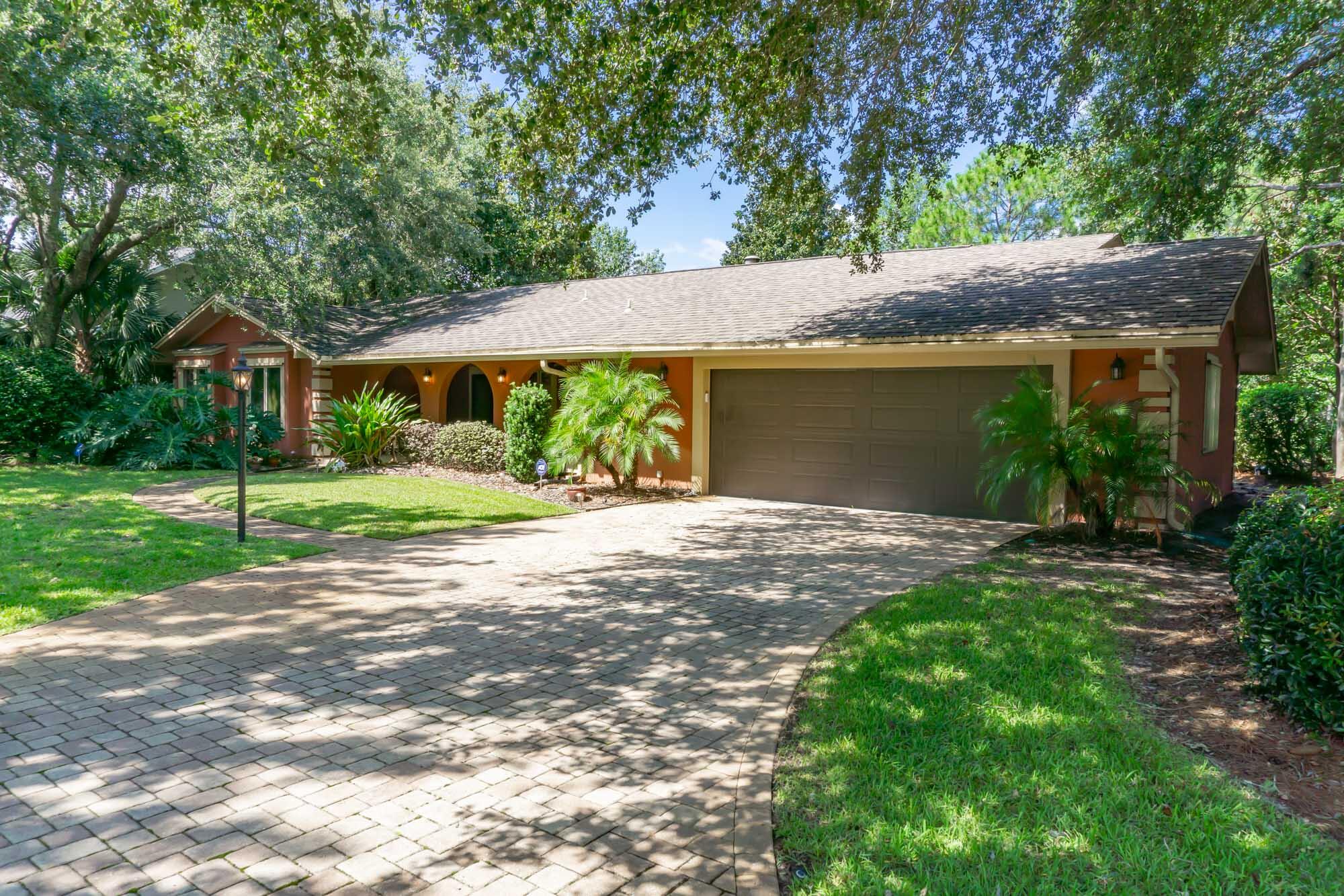 372 Golfview Drive Miramar Beach, FL 32550 - Photo 7 of 66 a front view of a house with a yard and trees