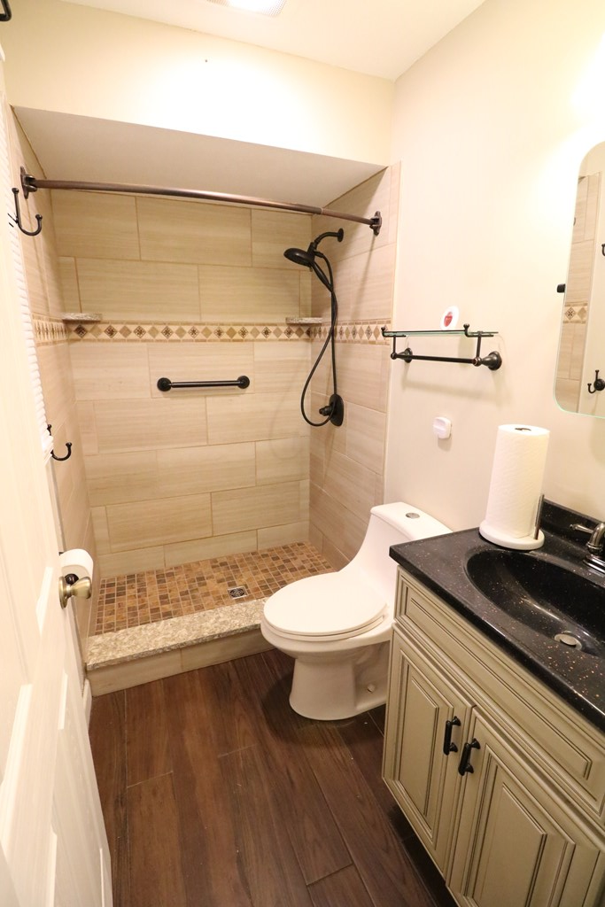 7 Primrose Court Columbus, GA 31907 - Photo 17 of 37 a bathroom with a granite countertop toilet and a shower