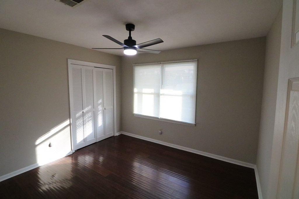 7 Primrose Court Columbus, GA 31907 - Photo 19 of 37 an empty room with wooden floor fan and windows