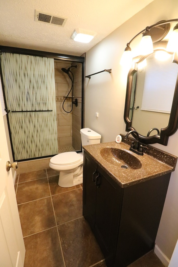 7 Primrose Court Columbus, GA 31907 - Photo 35 of 37 a bathroom with a granite countertop sink toilet and shower