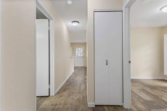 a view of a hallway with wooden floor