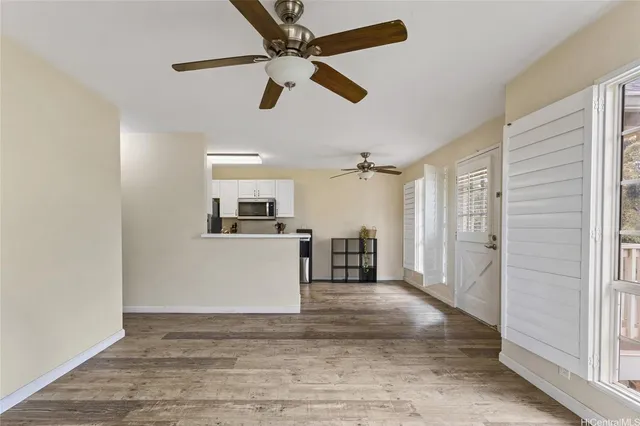 a view of a livingroom with a furniture wooden floor and window