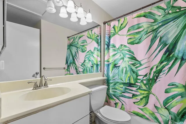 a bathroom with a sink a mirror and a toilet