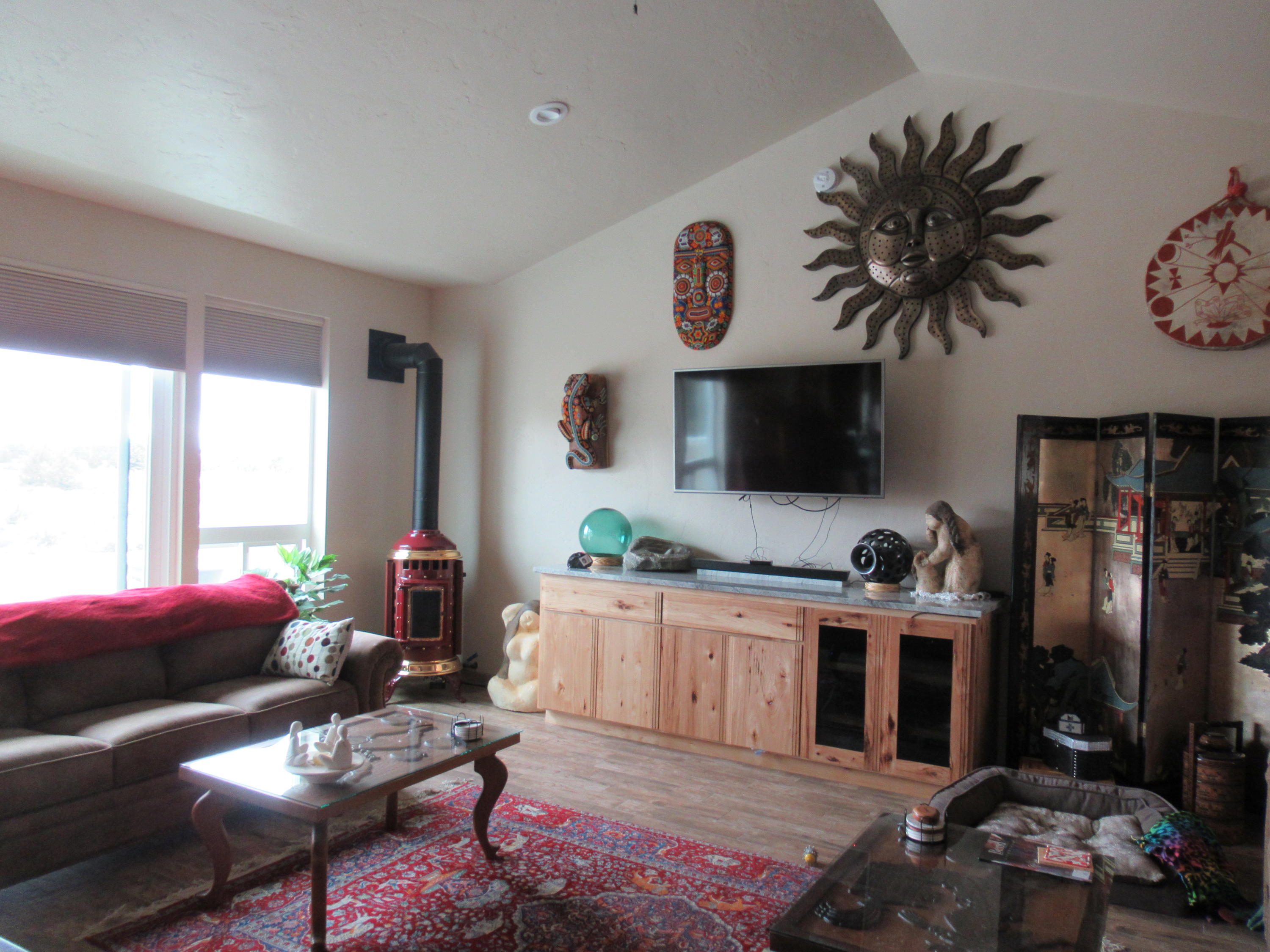 22063 Rickard Road Bend, OR 97702 - Photo 6 of 29 Living room has views, a great room with free-standing propane "pot belly" and a built in stereo cabinet, and chase behind tv allows wires to connect behind wall.
