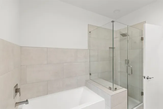 a bathroom with a bathtub and shower