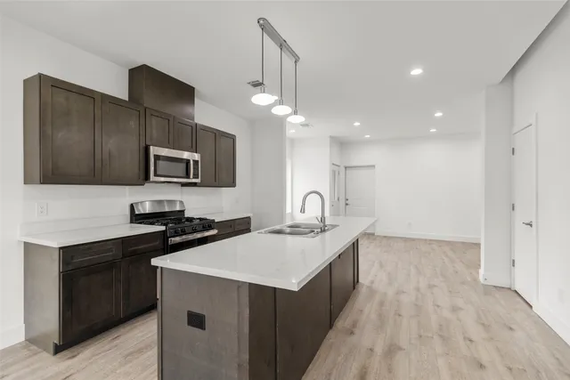 a kitchen with a sink appliances and cabinets