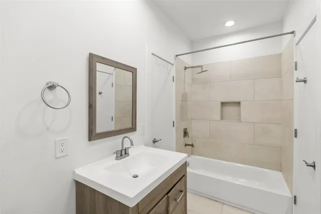 a bathroom with a sink mirror toilet and bathtub