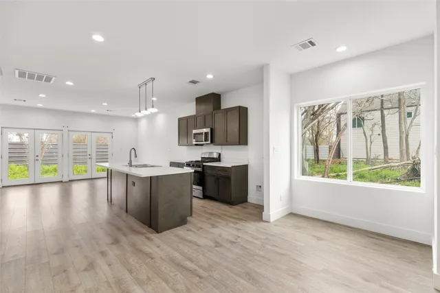 a large kitchen with a large counter top appliances and cabinets