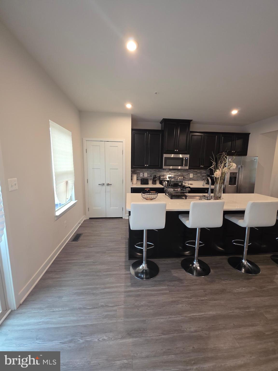 14510 Hunts Farm Road Brandywine, MD 20613 - Photo 24 of 74 a kitchen with a dining table chairs and a sink