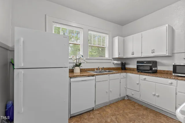 a kitchen with sink cabinets and appliances