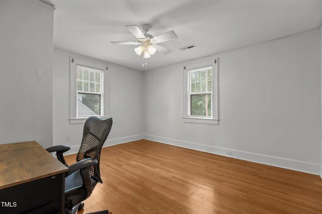 a view of hallway with wooden floor