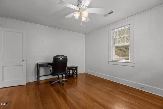 a view of a livingroom with furniture and chandelier fan