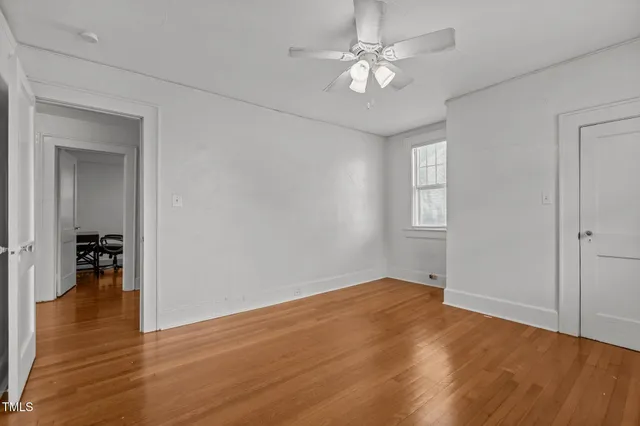 a view of a livingroom with a ceiling fan and window