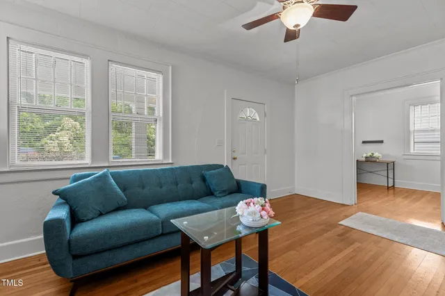 a living room with furniture a fireplace and a flat screen tv