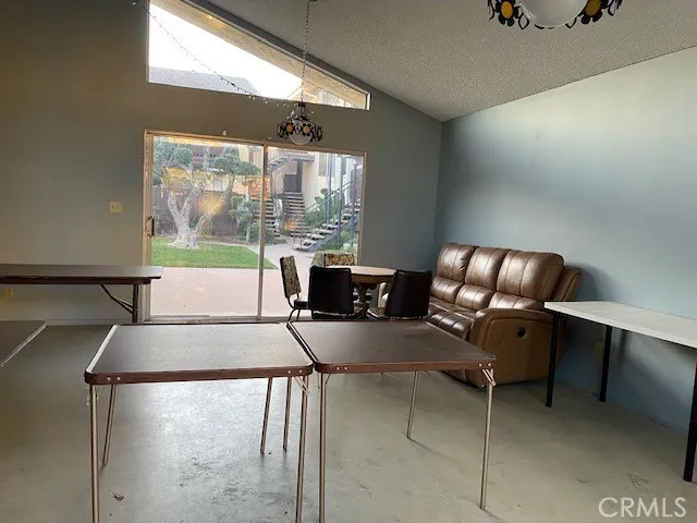 a living room with furniture and a floor to ceiling window