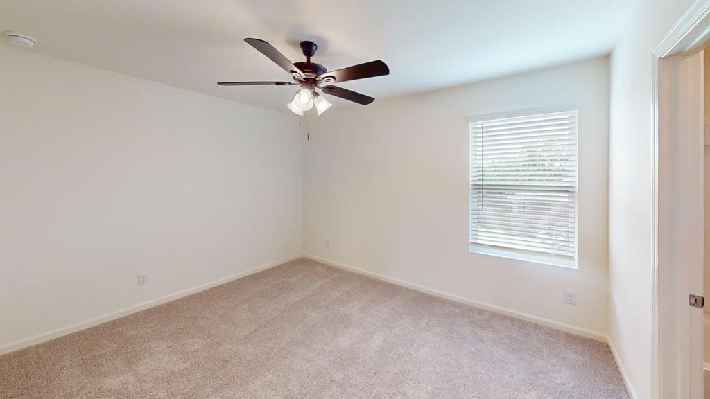 4529 Winecup Road Melissa, TX 75454 - Photo 12 of 29 Carpeted room with a ceiling fan light fixture, a single window with blinds, and neutral painted walls