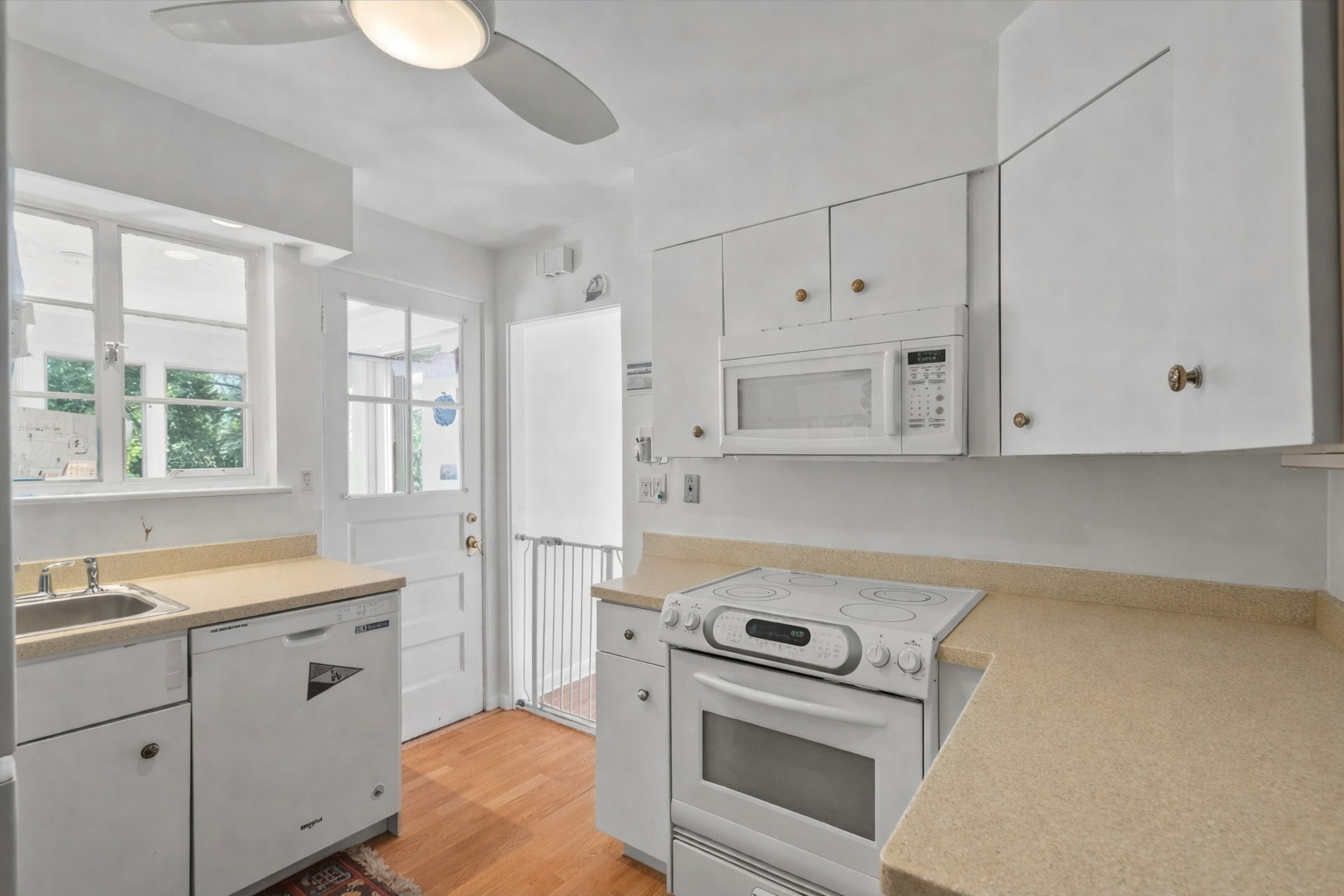 97 High Street Winnetka, IL 60093 - Photo 5 of 10 a kitchen with white cabinets and white appliances