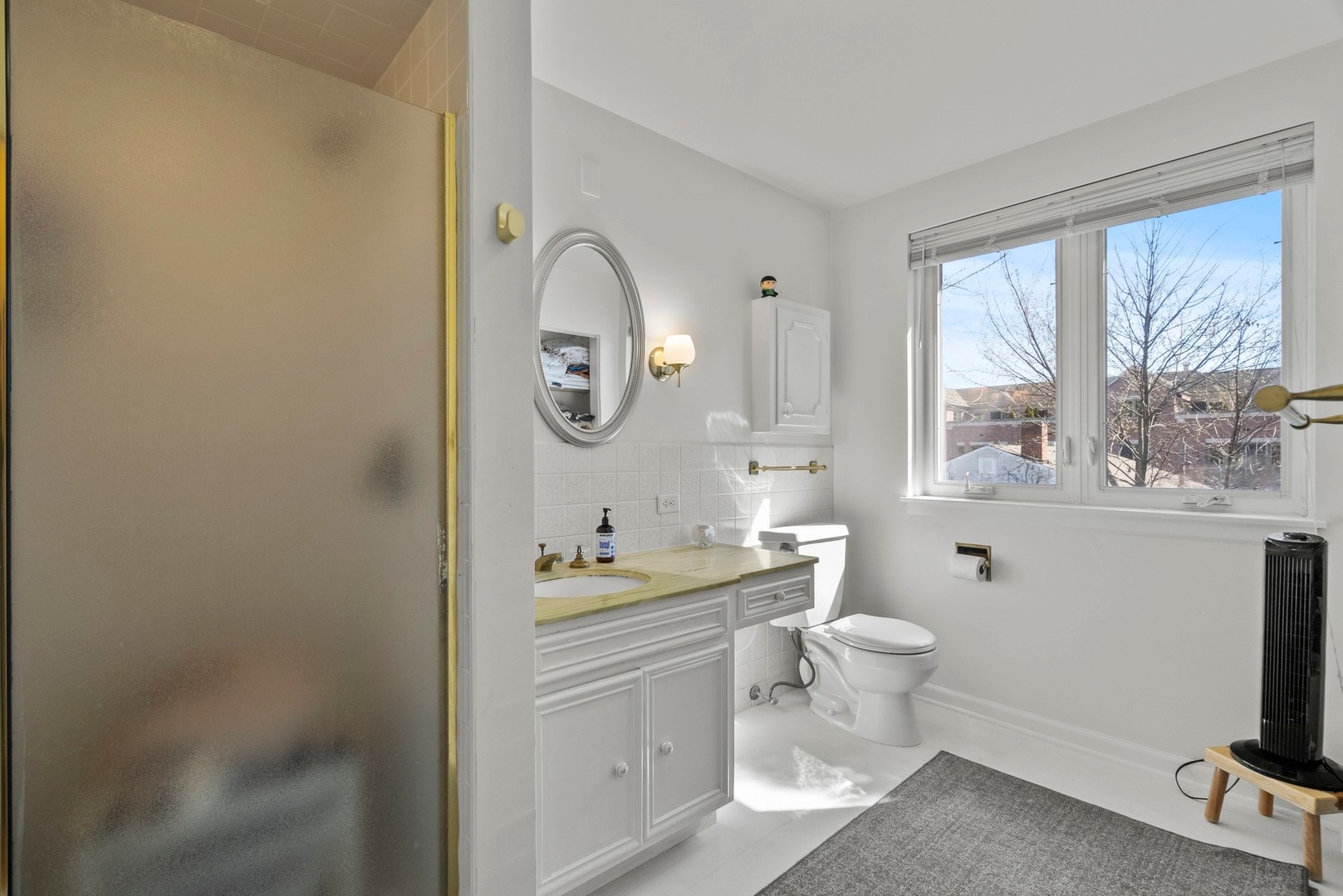 97 High Street Winnetka, IL 60093 - Photo 8 of 10 a bathroom with a toilet sink and mirror