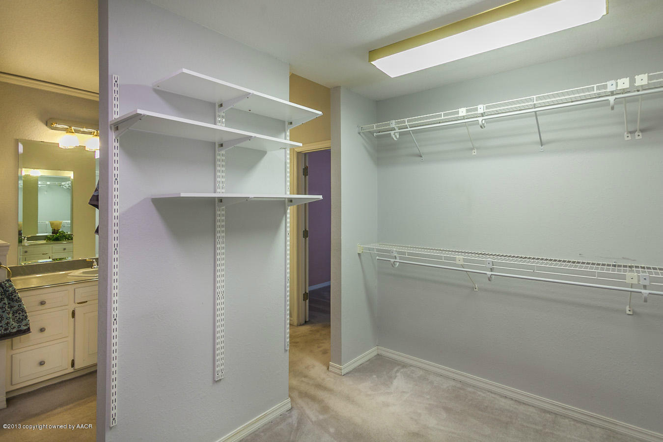 6707 Jameson Road Amarillo, TX 79106 - Photo 15 of 28 a view of walk in closet with empty racks