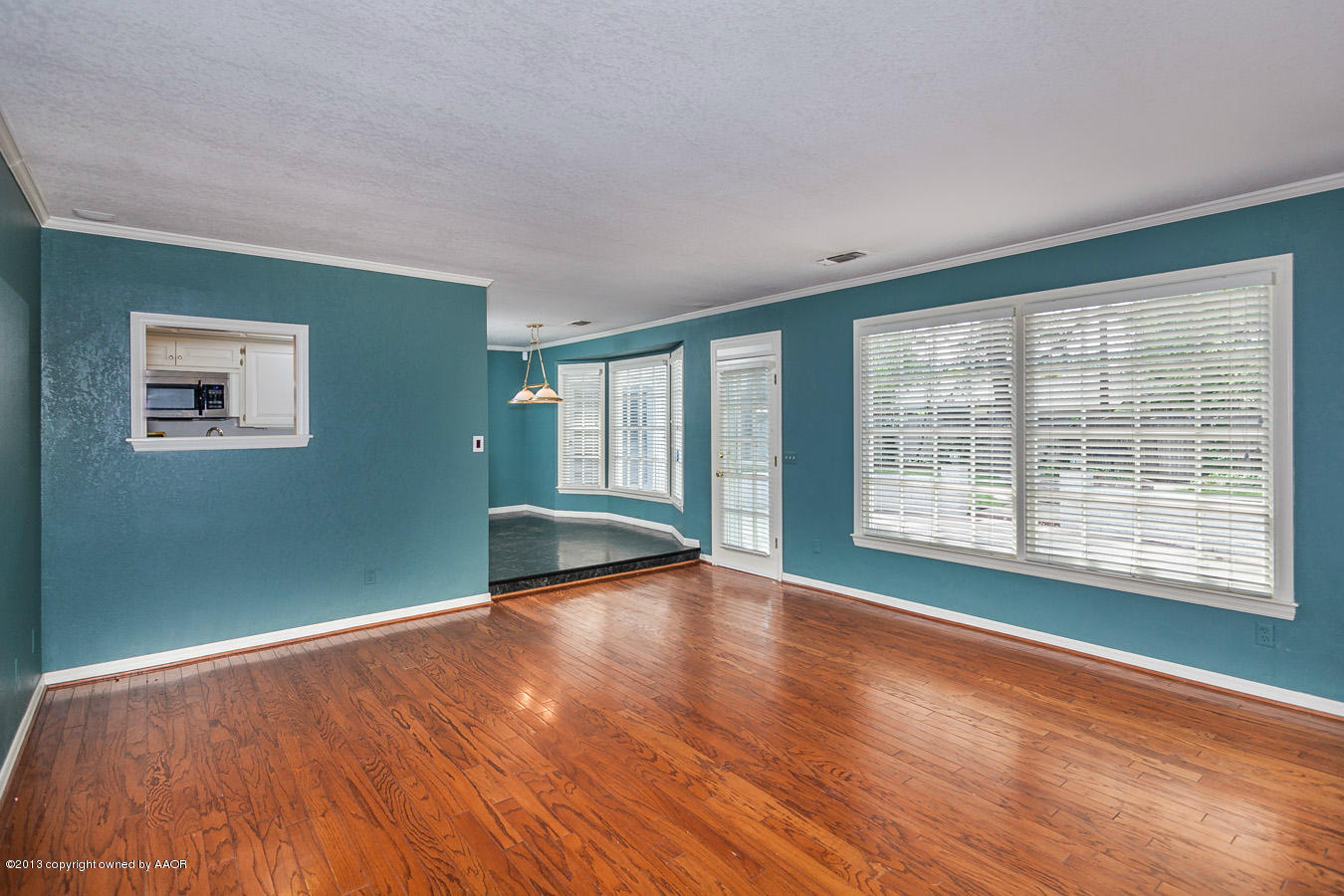 6707 Jameson Road Amarillo, TX 79106 - Photo 5 of 28 a view of an empty room with wooden floor and a window