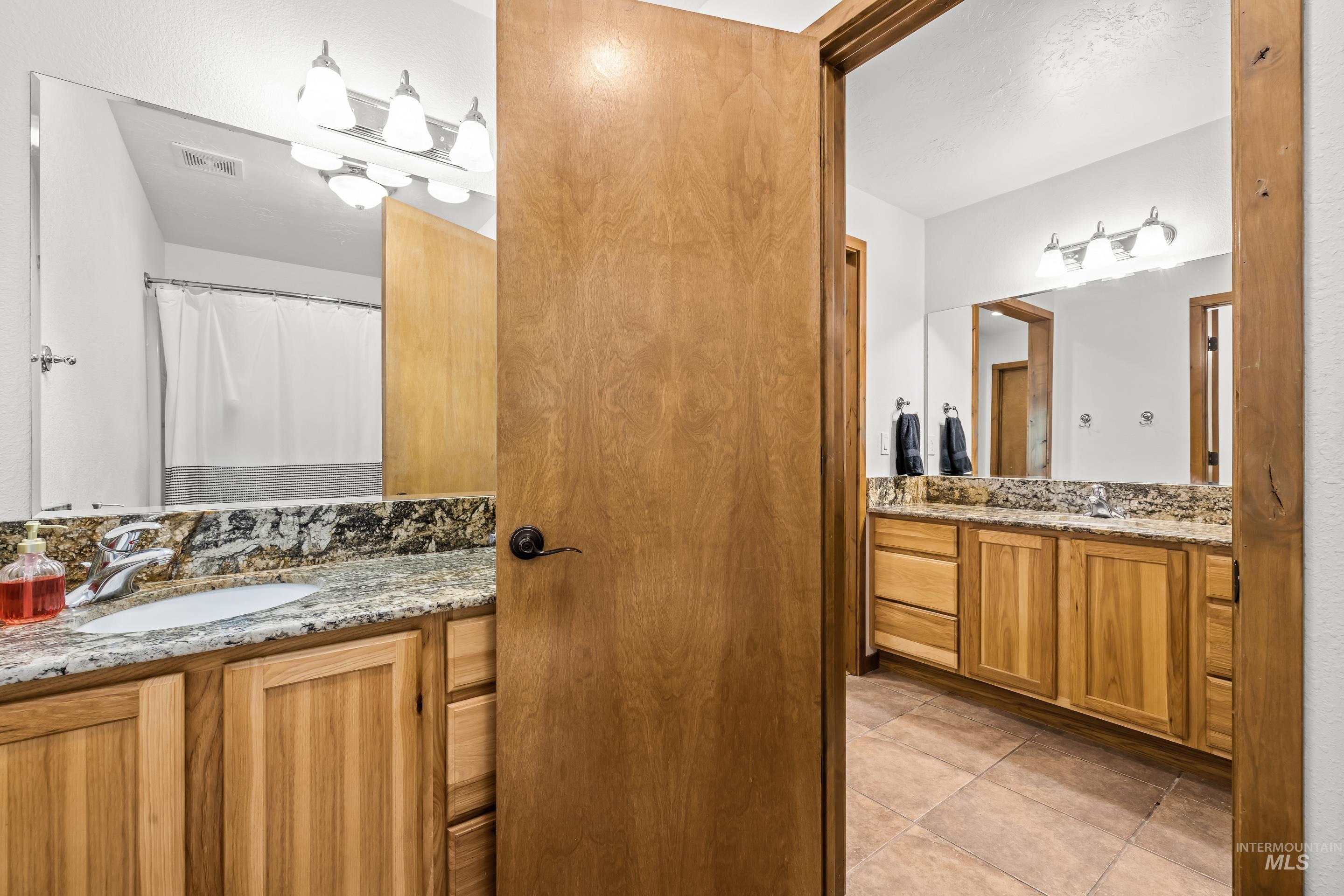 92 Cruickshank Road Horseshoe Bend, ID 83629 - Photo 37 of 50 Bathroom featuring dual vanities with granite countertops and wood-finish cabinetry