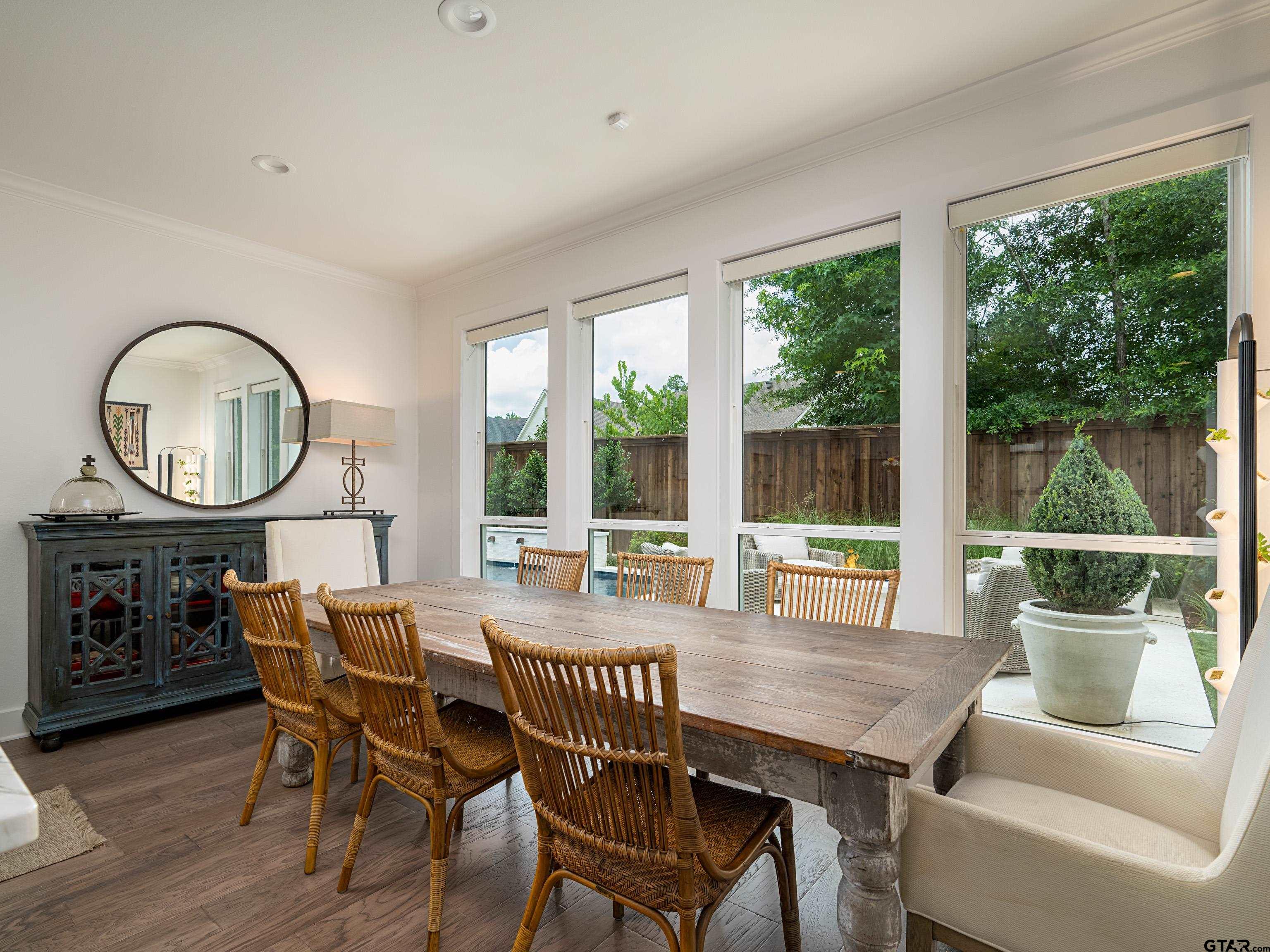 1555 Maple Lane Tyler, TX 75703 - Photo 12 of 43 a dining room with furniture a rug and a large window