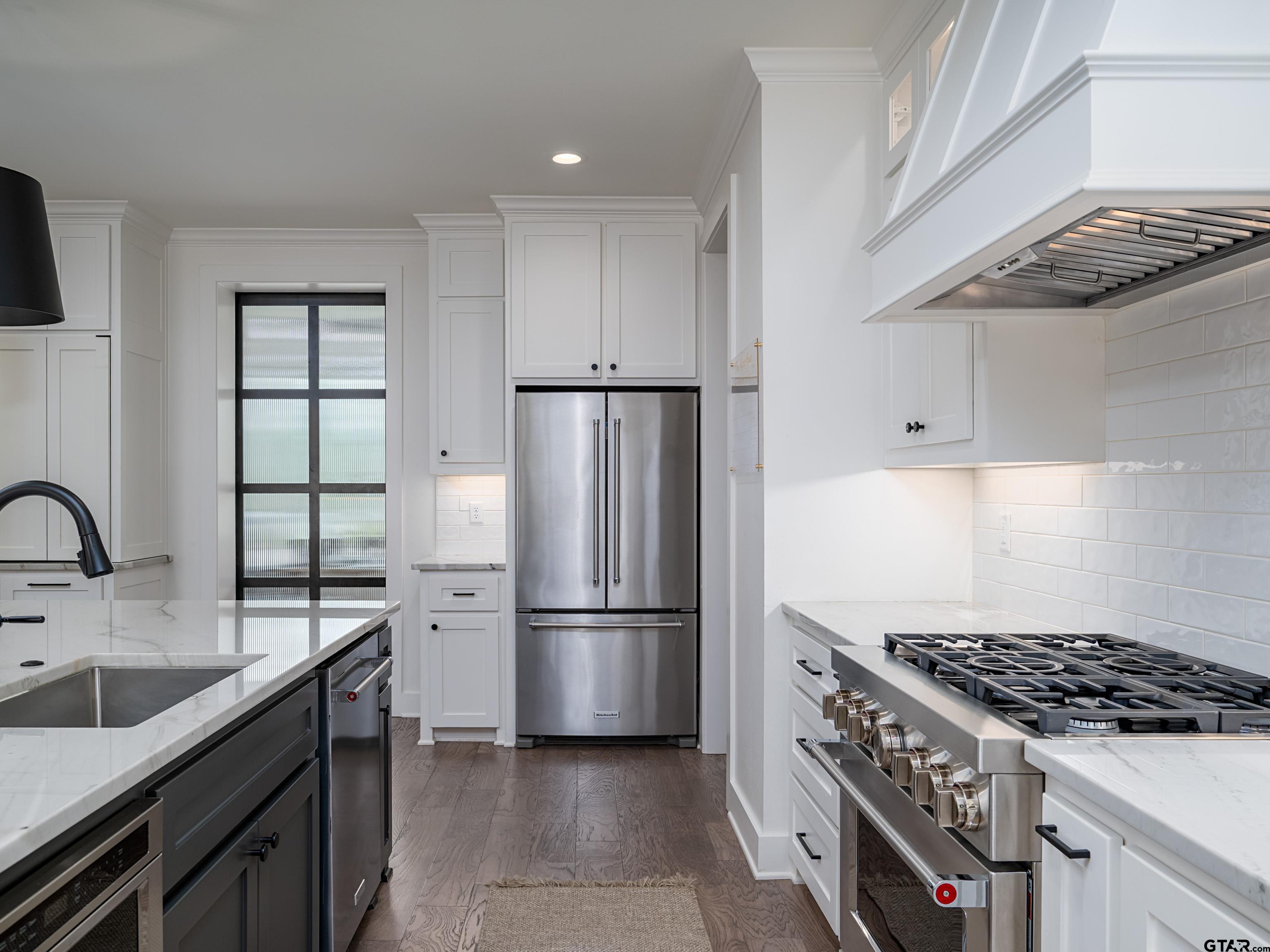 1555 Maple Lane Tyler, TX 75703 - Photo 13 of 43 a kitchen with stainless steel appliances granite countertop a sink stove and refrigerator