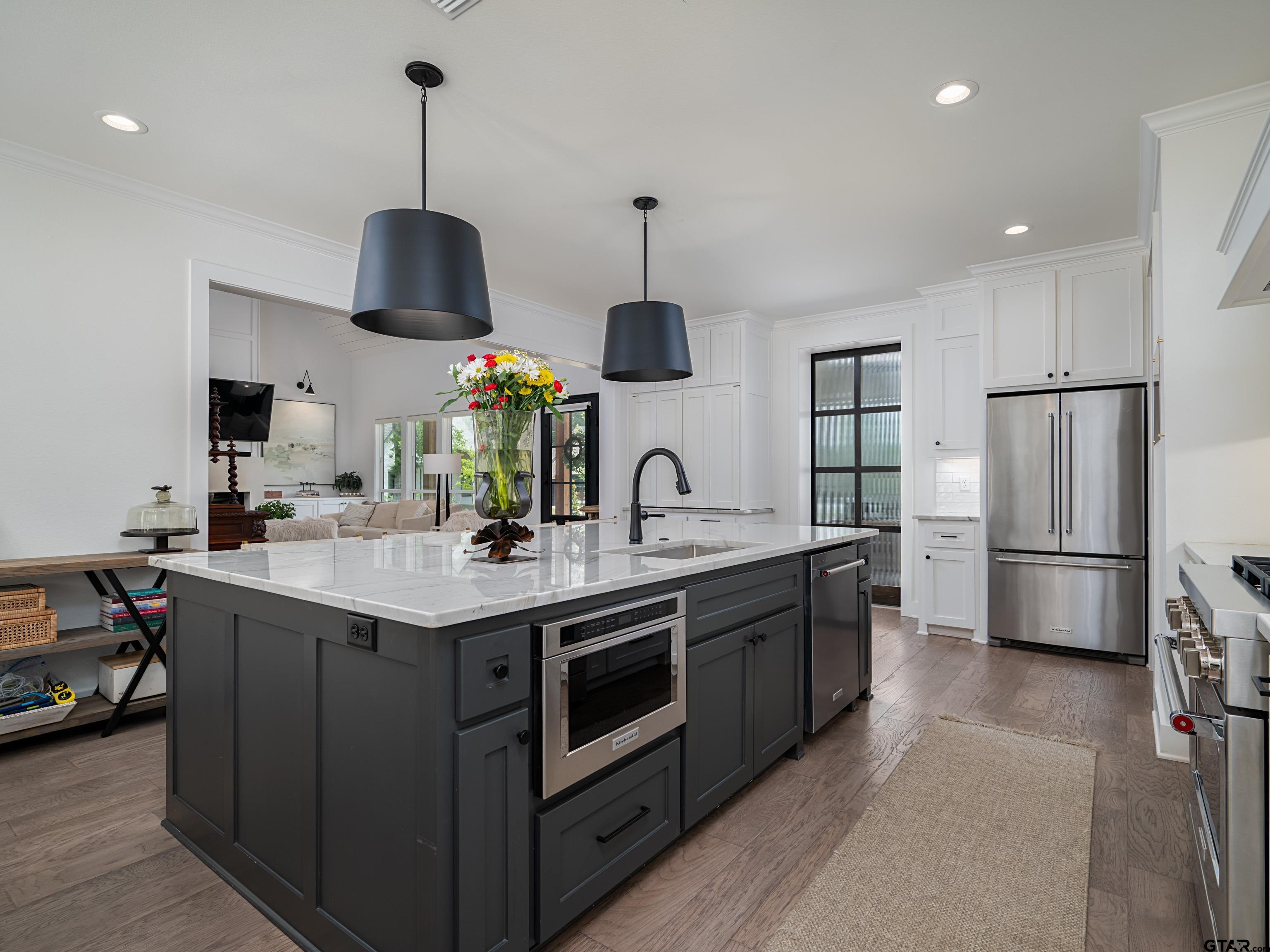 1555 Maple Lane Tyler, TX 75703 - Photo 15 of 43 a kitchen with stainless steel appliances granite countertop a sink a stove and a refrigerator