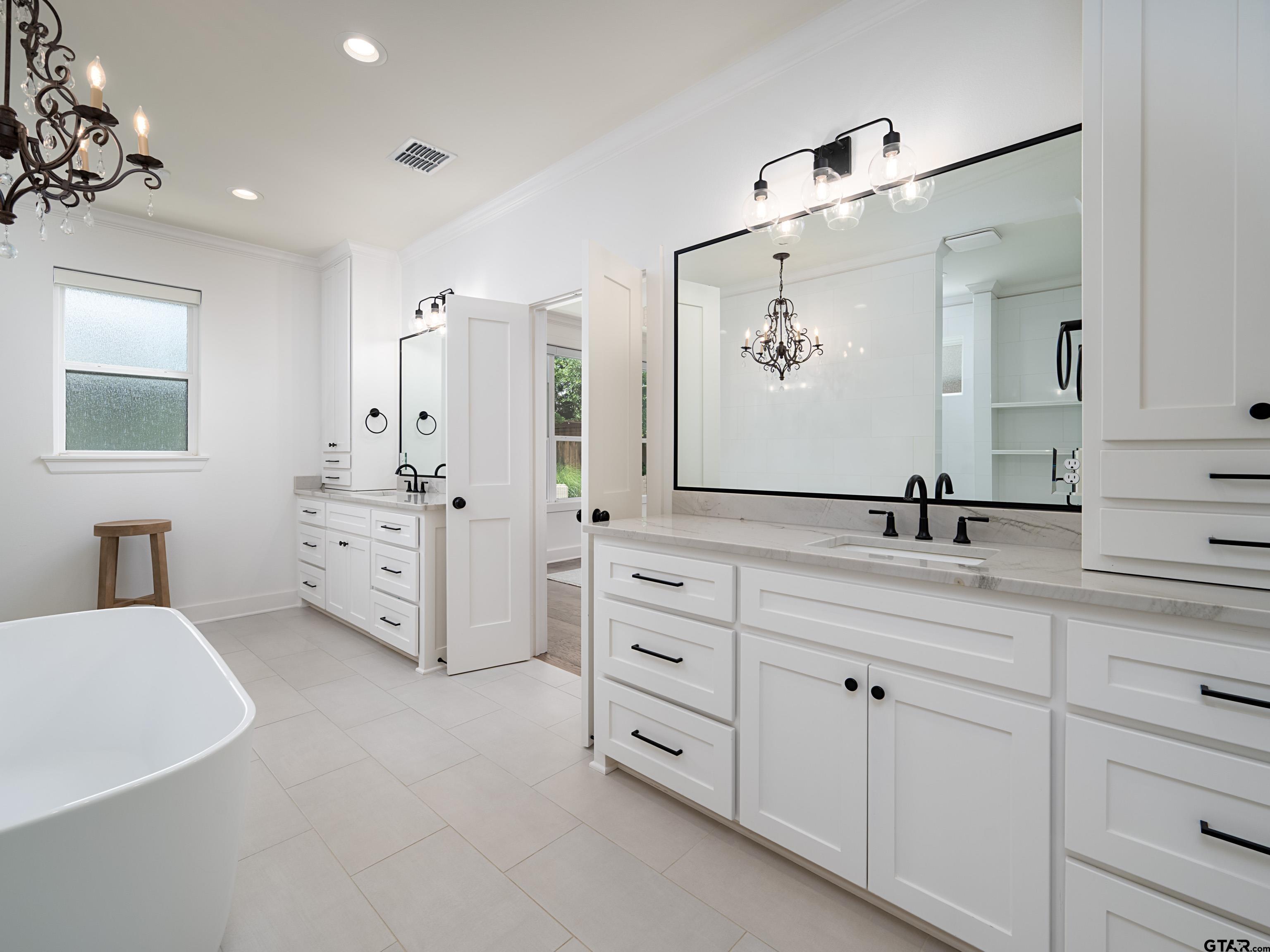 1555 Maple Lane Tyler, TX 75703 - Photo 21 of 43 a spacious bathroom with double vanity sink a mirror and a bathtub