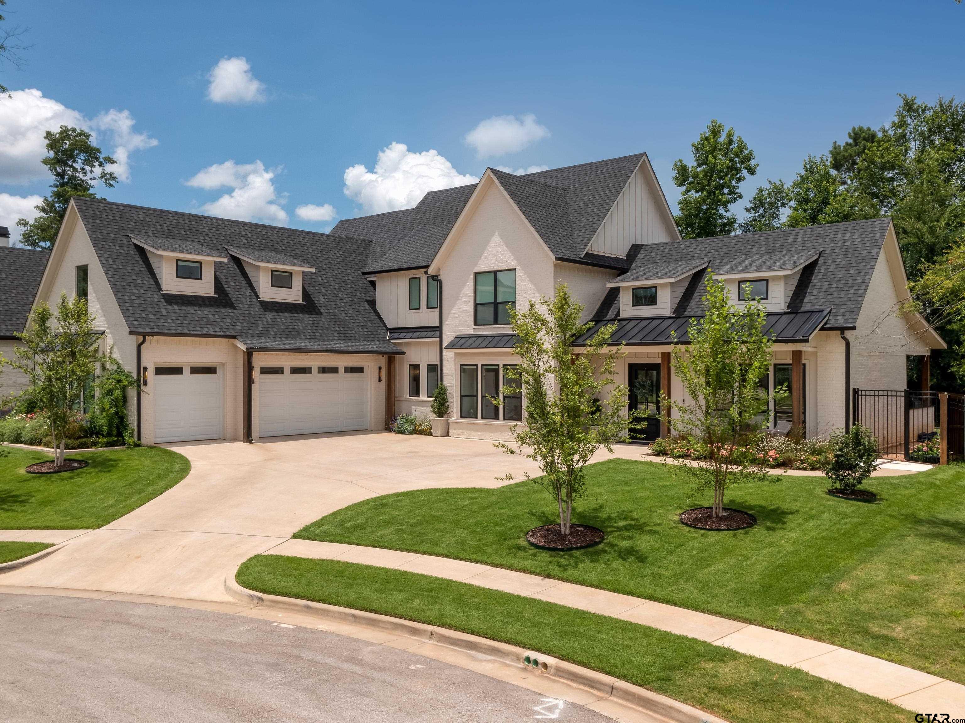 1555 Maple Lane Tyler, TX 75703 - Photo 3 of 43 a front view of a house with a yard and garage