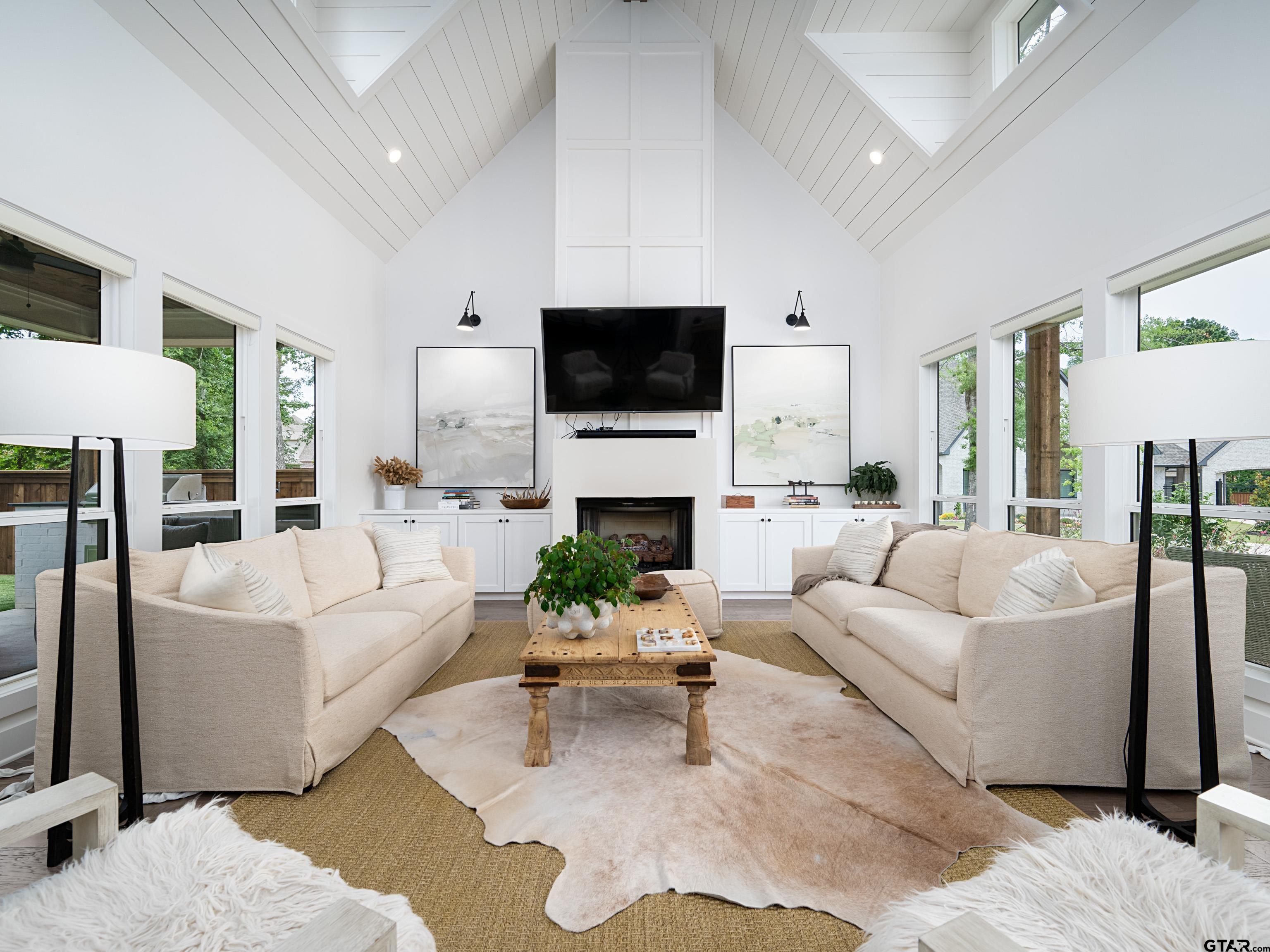 1555 Maple Lane Tyler, TX 75703 - Photo 9 of 43 a living room with furniture a flat screen tv and a fireplace