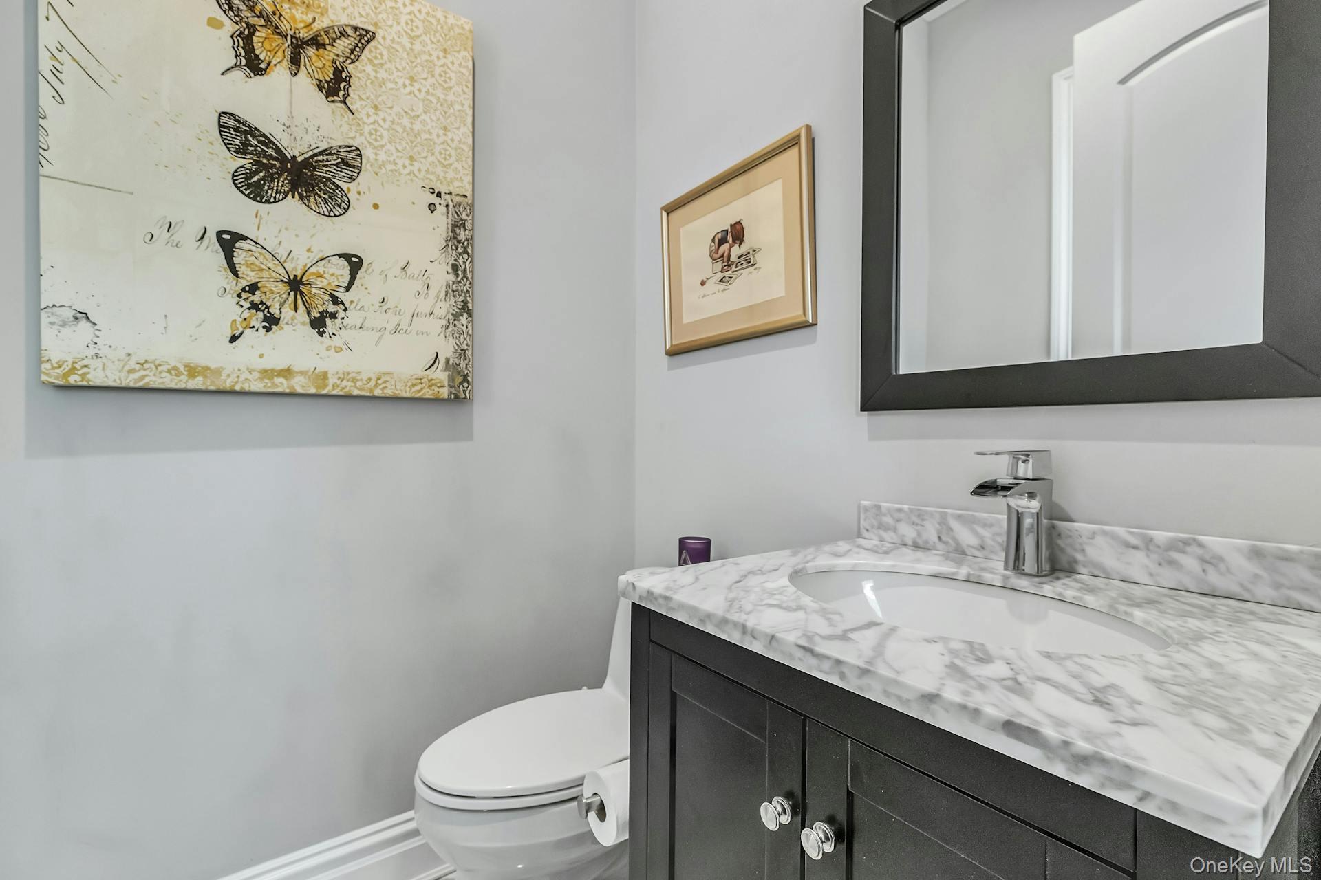 2 Seaman Road Glen Cove, NY 11542 - Photo 5 of 17 Powder room with vanity and mirror.