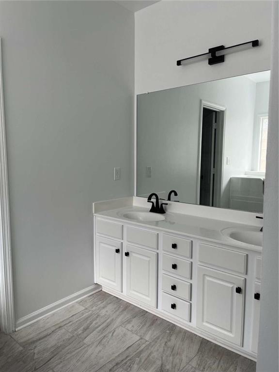 6127 Landers Loop Fairburn, GA 30213 - Photo 12 of 20 a spacious bathroom with a double vanity sink and mirror