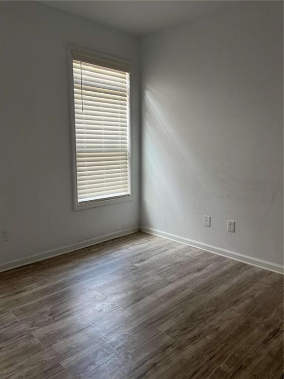 6127 Landers Loop Fairburn, GA 30213 - Photo 18 of 20 a view of an empty room with wooden floor and a window
