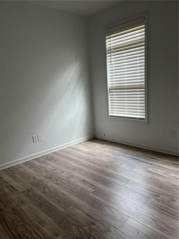 6127 Landers Loop Fairburn, GA 30213 - Photo 19 of 20 an empty room with wooden floor and a window