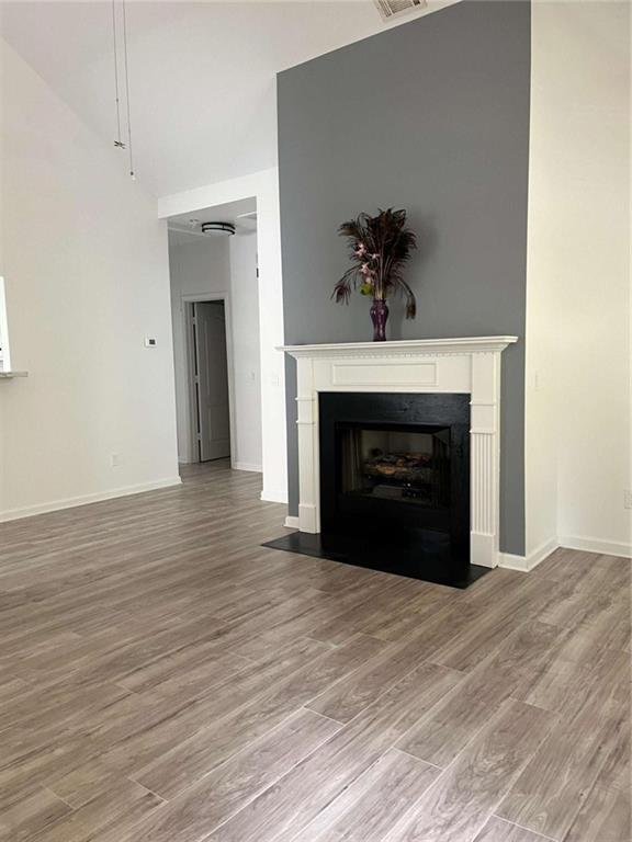 6127 Landers Loop Fairburn, GA 30213 - Photo 4 of 20 a view of an empty room with wooden floor fireplace and a window