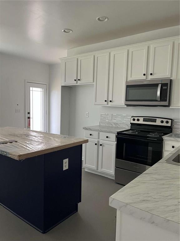 6127 Landers Loop Fairburn, GA 30213 - Photo 7 of 20 a kitchen with granite countertop a stove and a sink