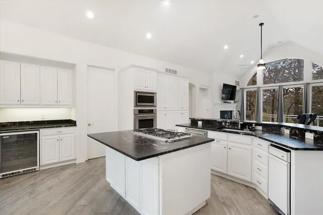 a kitchen with stainless steel appliances granite countertop a stove and a center island