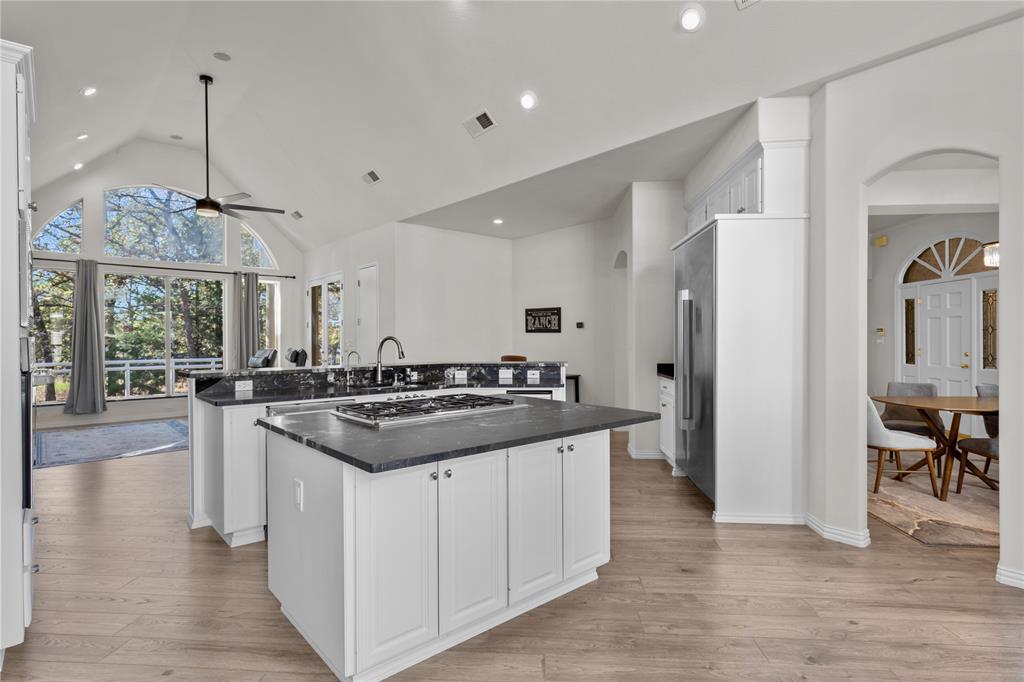 10984 Stagecoach Pass Pilot Point, TX 76258 - Photo 14 of 40 a kitchen with stainless steel appliances granite countertop a stove and a center island