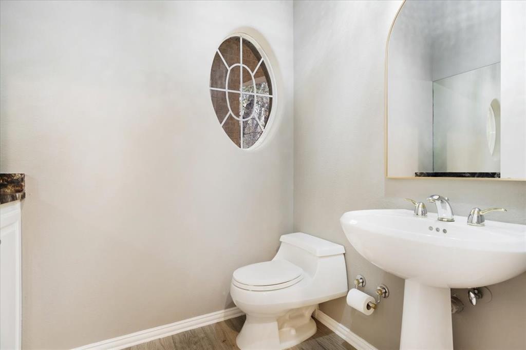 10984 Stagecoach Pass Pilot Point, TX 76258 - Photo 19 of 40 a bathroom with a sink a toilet and a mirror