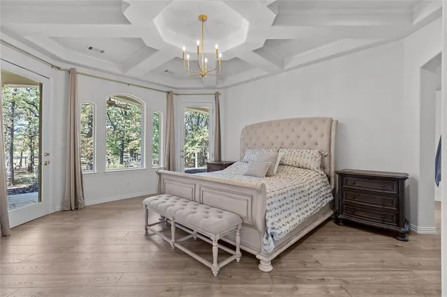 a bedroom with bed and wooden floor