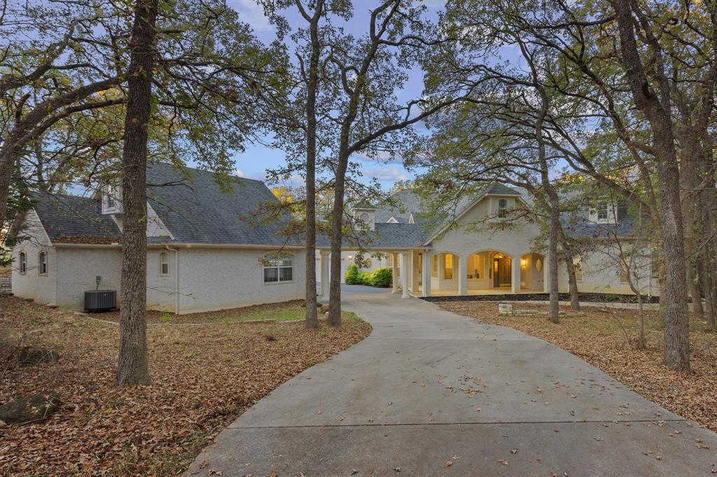 10984 Stagecoach Pass Pilot Point, TX 76258 - Photo 2 of 40 a view of a large white house with a large tree
