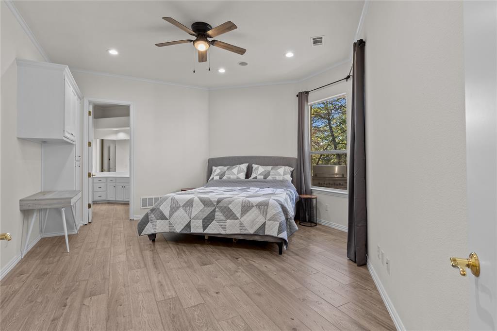 10984 Stagecoach Pass Pilot Point, TX 76258 - Photo 25 of 40 a bedroom with a bed and a table