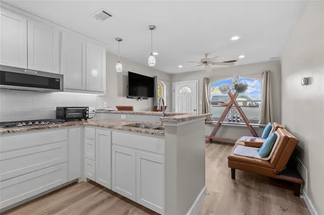 a view of a workspace with furniture and a window