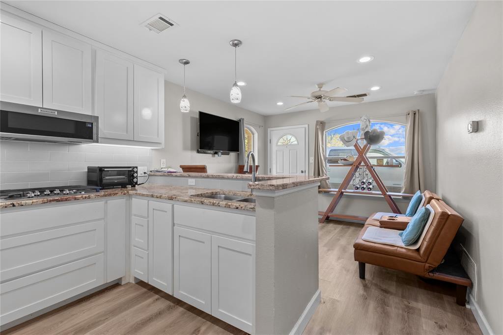 10984 Stagecoach Pass Pilot Point, TX 76258 - Photo 28 of 40 a living room with furniture a flat screen tv and kitchen view