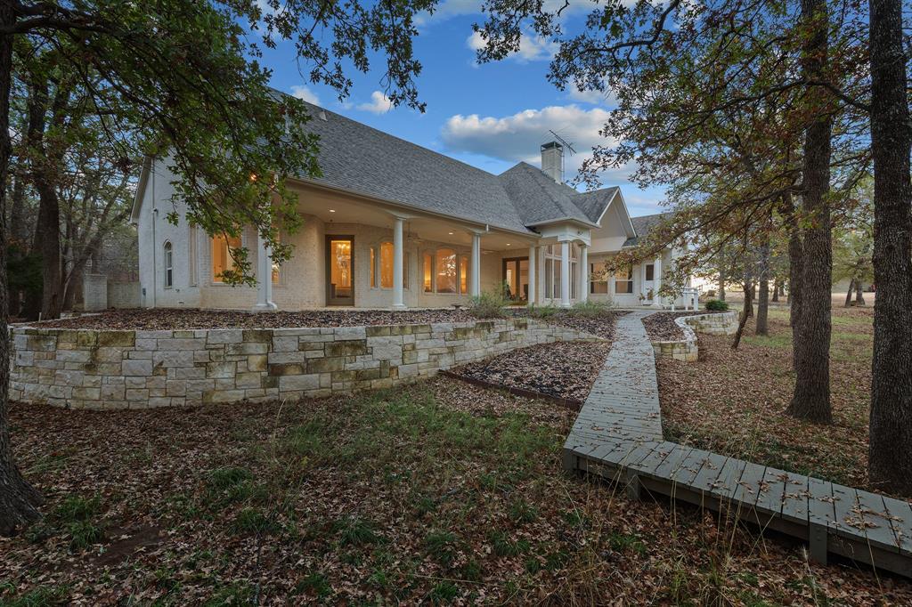 10984 Stagecoach Pass Pilot Point, TX 76258 - Photo 3 of 40 a front view of a house with a yard