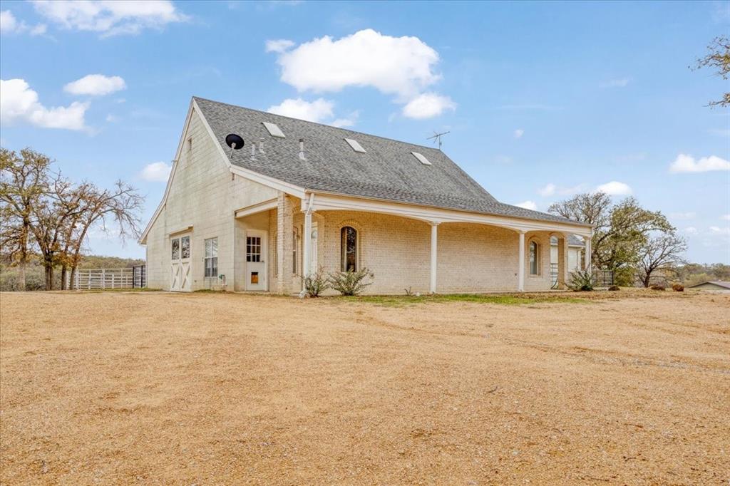 10984 Stagecoach Pass Pilot Point, TX 76258 - Photo 40 of 40 a front view of a house with a yard and garage