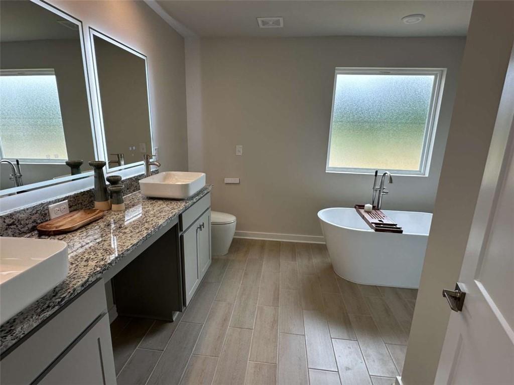 5372 Tolar Road South Fulton, GA 30213 - Photo 20 of 26 a bathroom with a granite countertop sink and a mirror