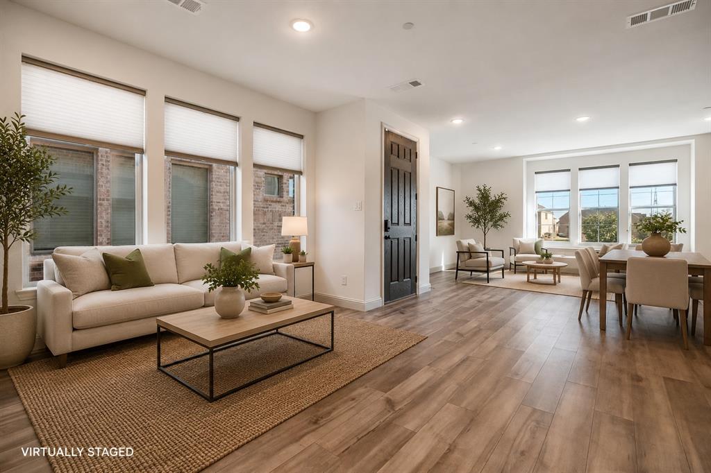 421 Matchbox Street Argyle, TX 76226 - Photo 12 of 40 Open-concept living space featuring wood-finish flooring, recessed lighting, and multiple large windows with blinds